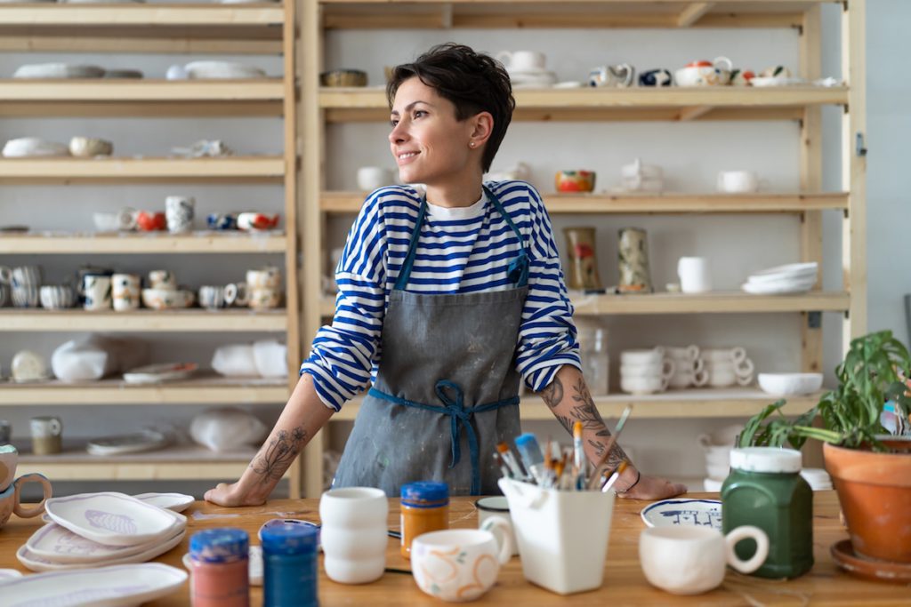 Calm,Young,Female,Owner,In,Pottery,Workshop,Looking,At,Window - Social Nation small business italy