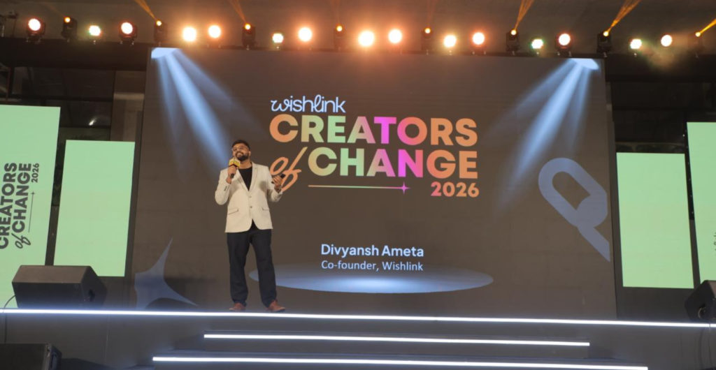 Speaker on a brightly lit stage delivering a talk at Creators of Change 2026 (Wishlink), with a colorful backdrop reading ‘Creators of Change 2026’.
