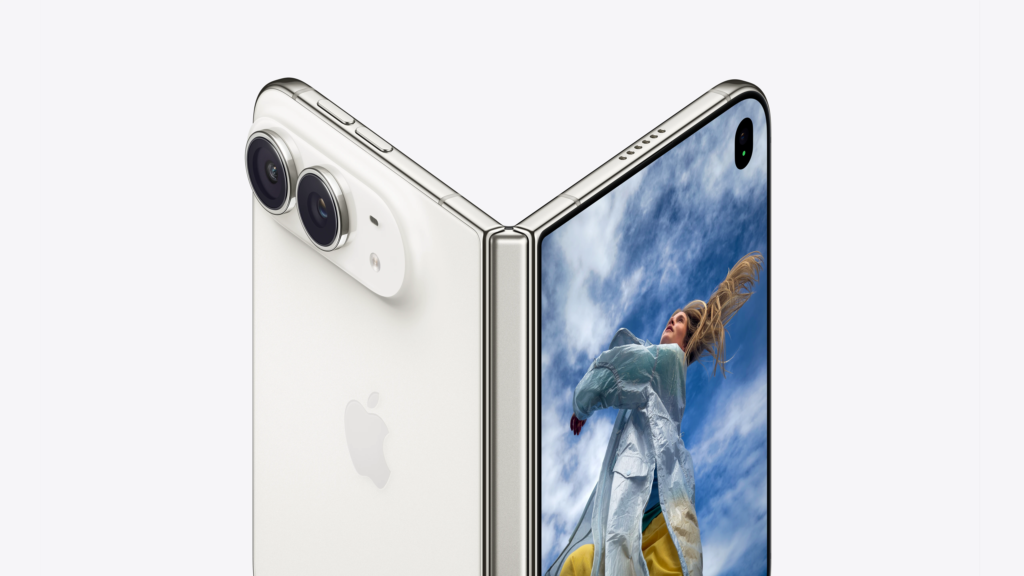 Close-up of a silver smartphone’s dual rear cameras and edge; screen shows a person outdoors on a blue-sky background from the display - Social Nation Close-up of a silver smartphone’s dual rear cameras and edge; screen shows a person outdoors on a blue-sky background from the display